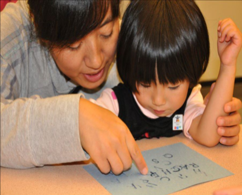Image 1 Mother and daughter looking at paper